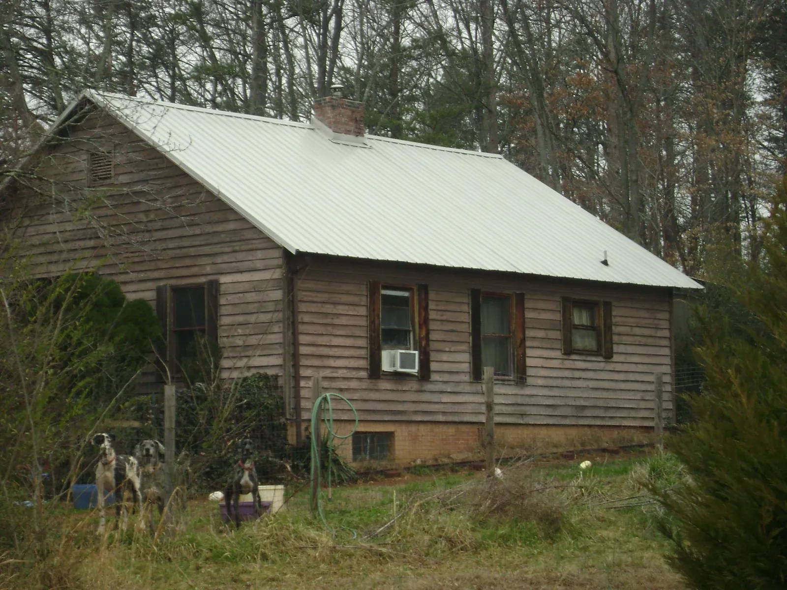 White metal roof on an old wood sided farmhouse, from a Metal Roof Installation job in East Lyme